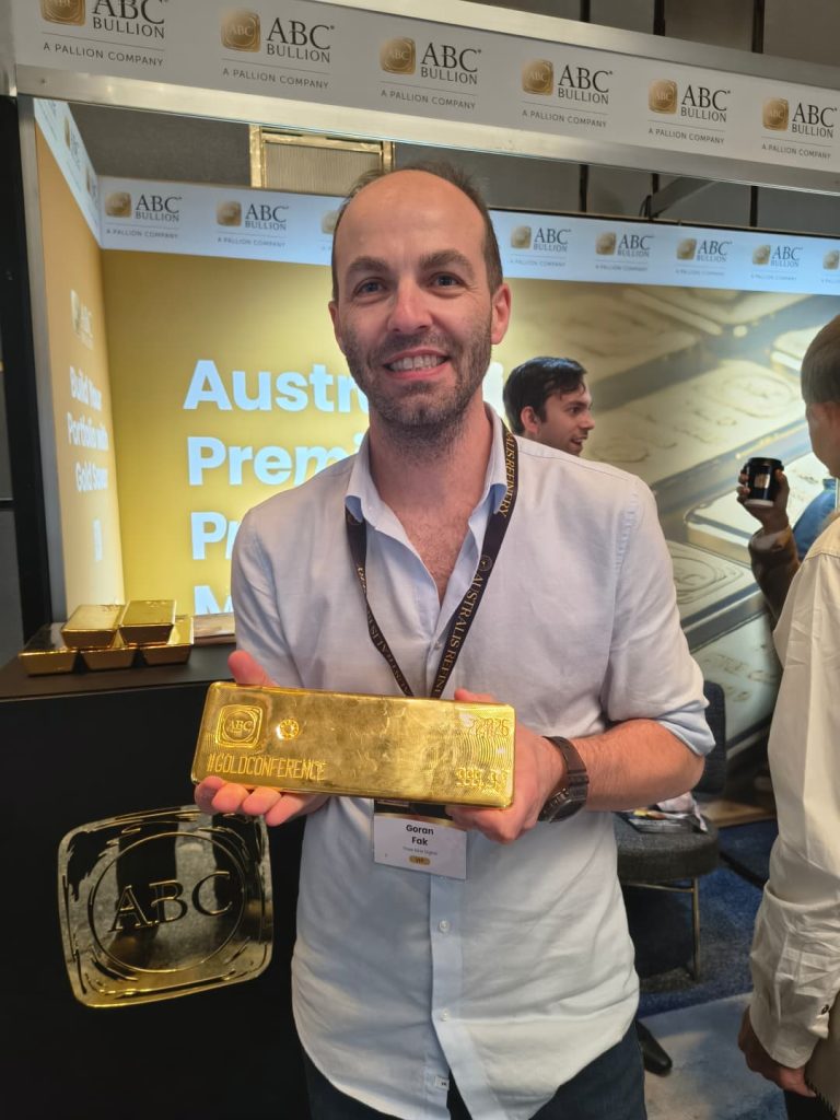 Goran holding a large ABC Bullion gold bar at the ABC Bullion stand, Australian Gold Conference 2026